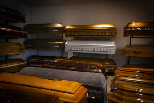 Coffins on display in a showroom.