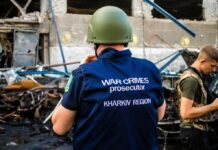 Russia’s Drone Barrage Stuns West – 14 Dead War crimes investigator in helmet at a damaged site