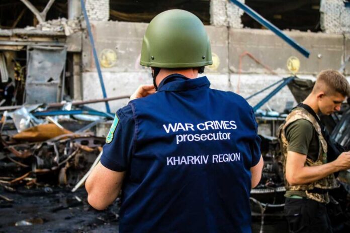 War crimes investigator in helmet at a damaged site