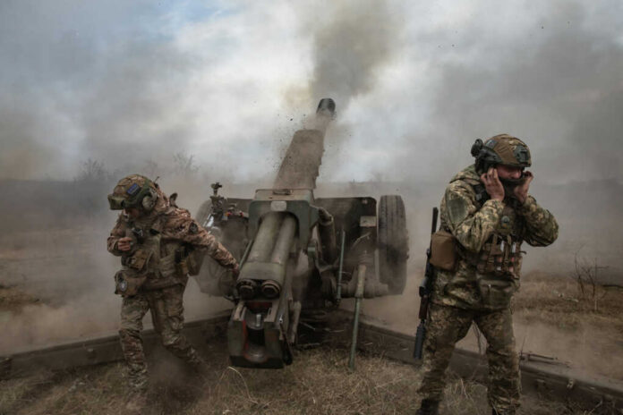 artillerymen2297836657jpg Soldiers fire a field howitzer as smoke and dust rise around them