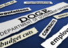 Budget and efficiency related words on torn paper strips
