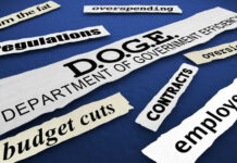 Budget and efficiency related words on torn paper strips