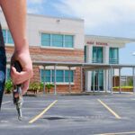 Person holding a handgun outside a high school building