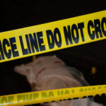 Mother’s Job Hunt Ends in Horrifying Tragedy Police tape and covered figure at crime scene