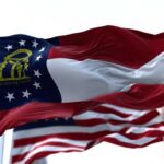 $4.2 Million Funnel: The Secret Abrams Campaign Plot Georgia state flag waving in the wind with an American flag in the background