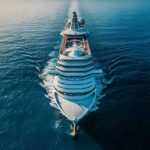 Deadly Virus Strikes Cruise Ship: 3 Dead Aerial view of a large cruise ship sailing on calm ocean waters