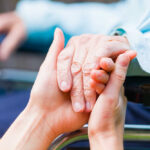 Michigan Democrats Push Death With Dignity Act Two hands clasped together, symbolizing care and support