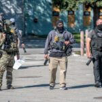 Law enforcement officers in tactical gear during an operation
