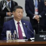 Beijing’s Tawain Threat Puts Trump in Tight Spot A leader seated at a conference table during an international summit