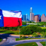 Texas flag waving in front of the Austin skyline
