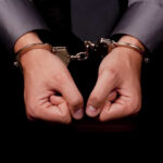 Armed Fugitive Feliciano Caught in Rhode Island Hands in handcuffs, symbolizing arrest or detention