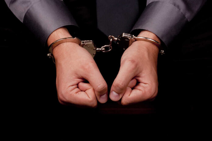 Hands in handcuffs, symbolizing arrest or detention