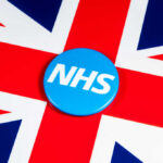 Lost Results: NHS Faces Life-or-Death Crisis Blue NHS badge on the Union Jack flag