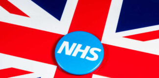 Blue NHS badge on the Union Jack flag