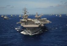 Aircraft carrier leads a naval fleet at sea