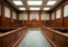 Empty blurred courtroom with wooden interior usa flags