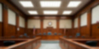Empty blurred courtroom with wooden interior usa flags