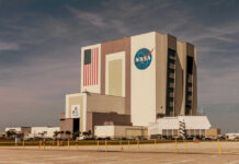 NASA’s Risky Docking Gamble NASAs Vehicle Assembly Building with Artemis sign.