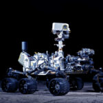 Mars rover with six wheels and camera mast on dark background