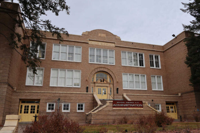 school-district-9-r-administration-building1574448448jpg Historic brick school building with arched entrance and large white-framed windows