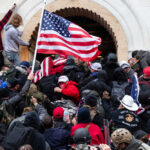 Moral Meltdown Grips America Crowd with American flag pushes into building entrance