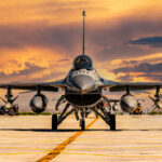 F-16 fighter jet on an airbase during sunset