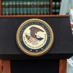 Podium with the Department of Justice seal and American flag in the background
