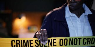 Police officer holding crime scene tape
