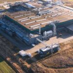 Kim Jong Un’s New Nuke Plant Stuns Washington Aerial view of a large industrial facility with various structures and equipment