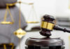 On-Duty Kidnapping Shocks Indiana A wooden gavel resting on a sound block with a blurred scale of justice in the background