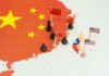 Map with chess pieces and flags on China
