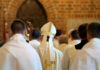 Huge Payout, Bigger Exposure Clerics in white robes facing altar in church