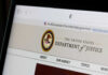 Close-up of the U.S. Department of Justice website on a computer screen