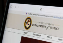 DOJ Threat Puts Election Chiefs On Notice Close-up of the U.S. Department of Justice website on a computer screen