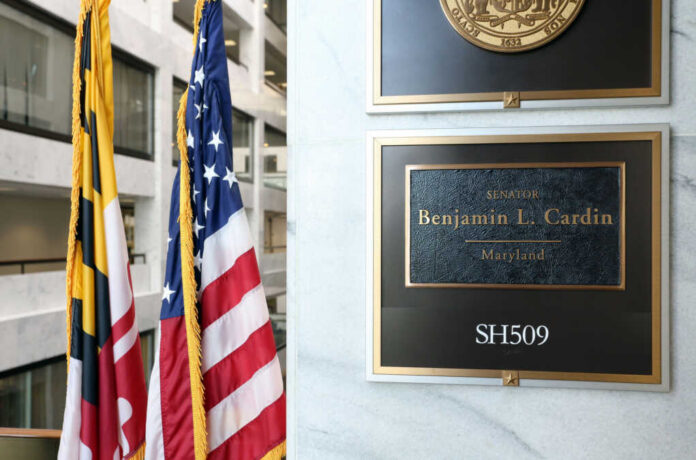 office-entrance-ben-cardin743195380jpg Office plaque beside U.S. and state flags in a government building