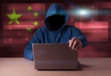 Foreign Money, Hidden Strings at Georgetown Hooded figure using a laptop with red cybersecurity graphics