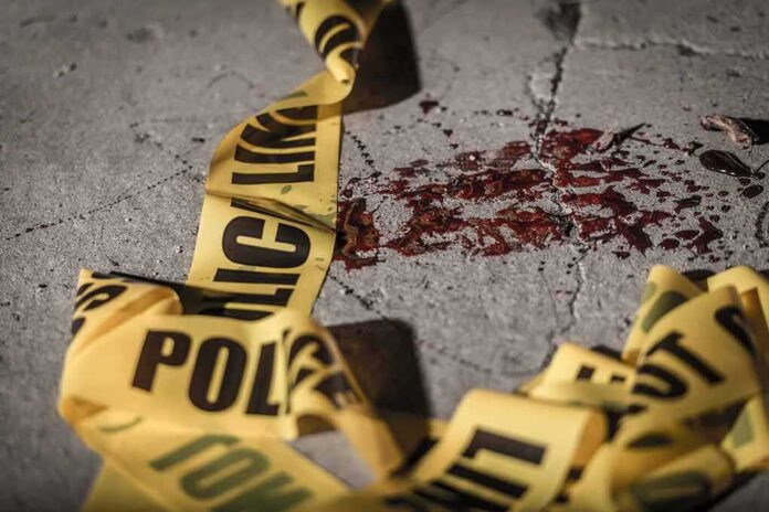 shutterstock_1089277004-1 Crime scene tape near blood on pavement