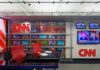 Trump Torches Reporter’s Win — Then What? CNN newsroom set with red chairs and multiple TVs