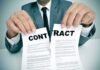 Person in suit tearing a contract in half