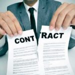 FBI Probes Blockbuster-Backed Money Mirage Person in suit tearing a contract in half