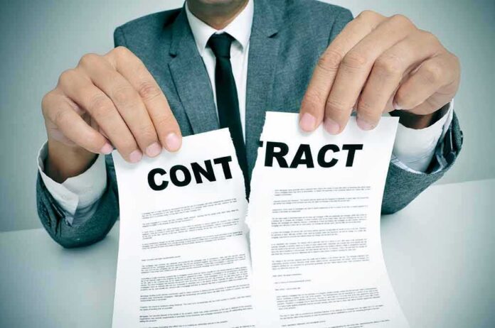 shutterstock_162854627 Person in suit tearing a contract in half
