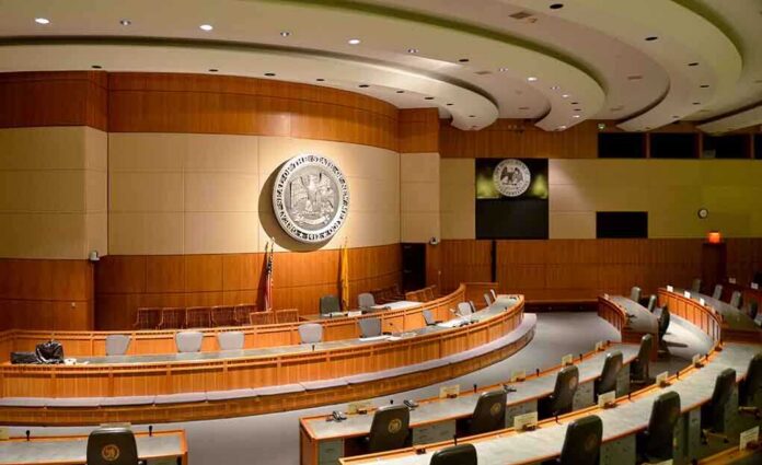 Interior view of a government chamber with wooden paneling and seating