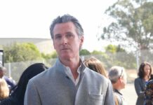 Newsom’s Housing Gamble Sparks Street Fury man in gray coat at an outdoor event
