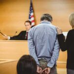 DNA Dragnet Nails Fresno Predator Defendant in handcuffs stands before a judge in a courtroom