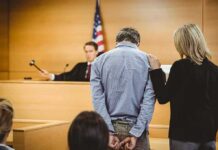 DNA Dragnet Nails Fresno Predator Defendant in handcuffs stands before a judge in a courtroom
