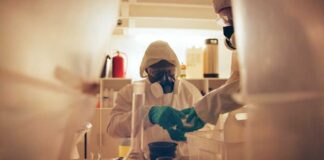 Scientists in protective gear conducting an experiment in a laboratory