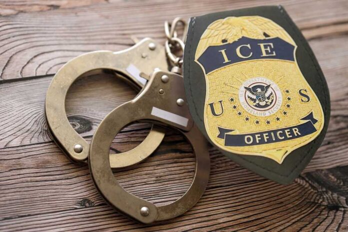 Kyiv,,Ukraine,-,September,17,,2025,Us,Ice,Officer,Badge Handcuffs and a police badge on a wooden surface