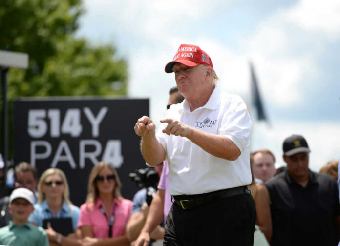 trump-reacts-to-the-liv-golf-fans2186856157jpg Man in red cap and white golf shirt gesturing at a golf event