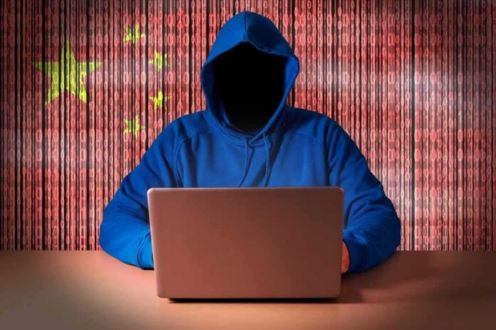 shutterstock_1024090987-2 Hooded figure using a laptop