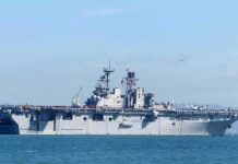 Aircraft carrier sailing on calm blue water